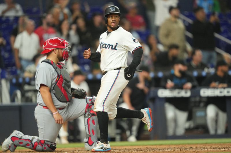 Aug 19, 2025; Miami, Florida, USA;  Miami Marlins second baseman Xavier Edwards (9) scores a run in the fourth inning against the St. Louis Cardinals at loanDepot Park. Mandatory Credit: Jim Rassol-Imagn Images