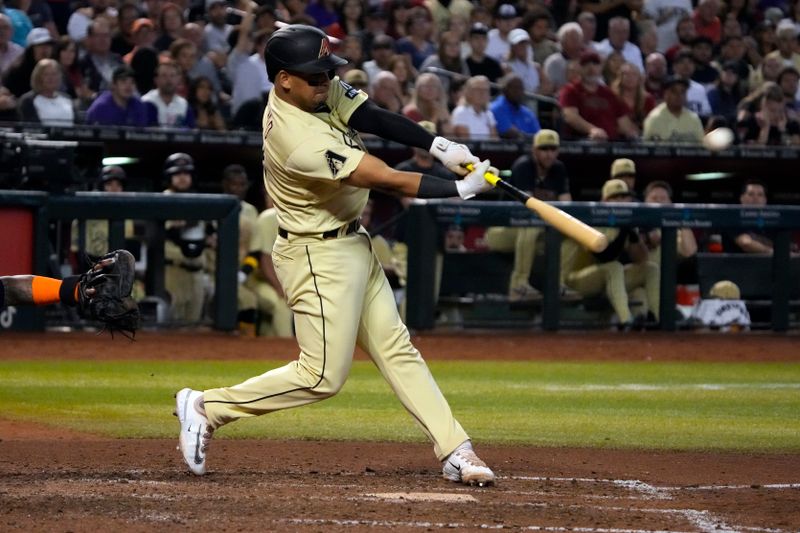 Sep 29, 2023; Phoenix, Arizona, USA; Arizona Diamondbacks catcher Gabriel Moreno (14) hits an RBI double against the Houston Astros in the ninth inning at Chase Field. Mandatory Credit: Rick Scuteri-USA TODAY Sports