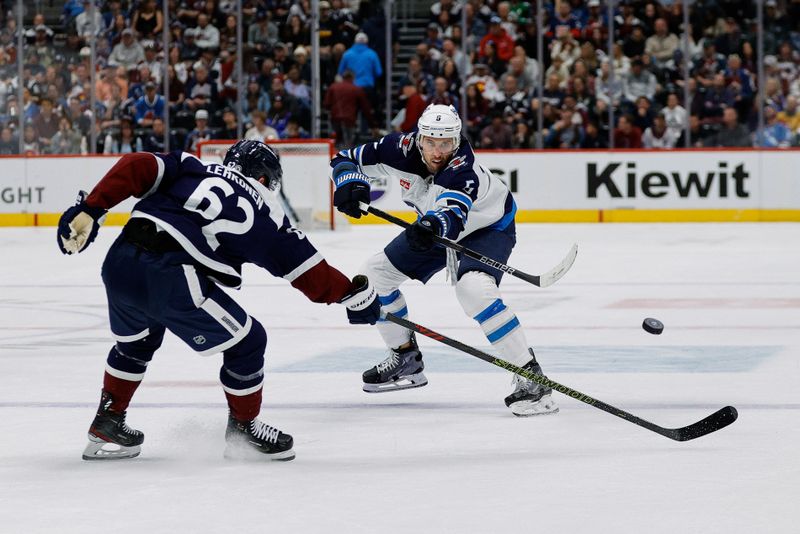 Apr 13, 2024; Denver, Colorado, USA; Winnipeg Jets defenseman Brenden Dillon (5) passes the puck as Colorado Avalanche left wing Artturi Lehkonen (62) defends in the first period at Ball Arena. Mandatory Credit: Isaiah J. Downing-USA TODAY Sports