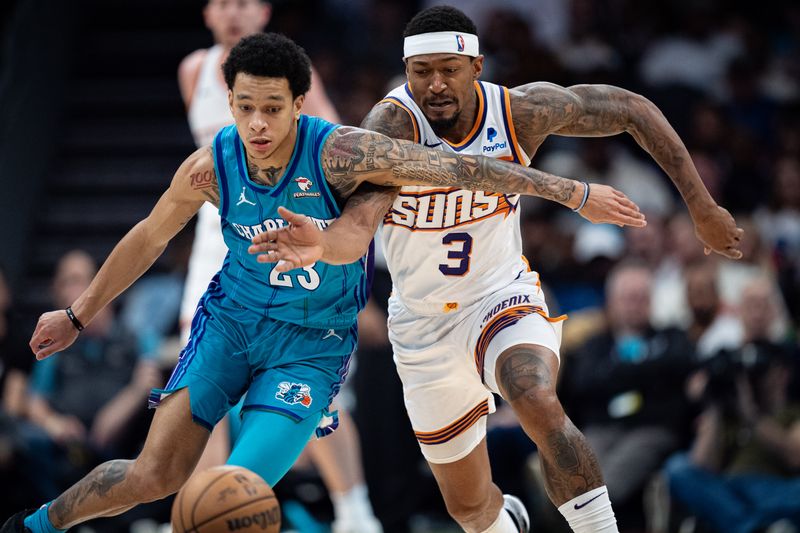 CHARLOTTE, NORTH CAROLINA - MARCH 15: Tre Mann #23 of the Charlotte Hornets and Bradley Beal #3 of the Phoenix Suns fight for the ball in the third quarter during their game at Spectrum Center on March 15, 2024 in Charlotte, North Carolina. NOTE TO USER: User expressly acknowledges and agrees that, by downloading and or using this photograph, User is consenting to the terms and conditions of the Getty Images License Agreement. (Photo by Jacob Kupferman/Getty Images)