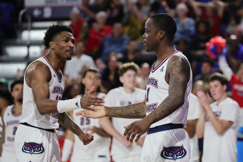 Jan 28, 2024; Boca Raton, Florida, USA; Florida Atlantic Owls guard Johnell Davis (1) celebrates with guard Brandon Weatherspoon (23) against the North Texas Mean Green during the second half at Eleanor R. Baldwin Arena. Mandatory Credit: Sam Navarro-USA TODAY Sports