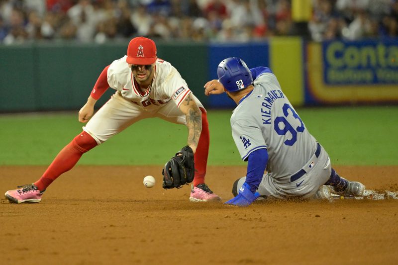 Sep 3, 2024; Anaheim, California, USA;  Los Angeles Angels shortstop Zach Neto (9) can’t hold on to the ball as Los Angeles Dodgers center fielder Kevin Kiermaier (93) steals second in the tenth inning at Angel Stadium. Mandatory Credit: Jayne Kamin-Oncea-Imagn Images
