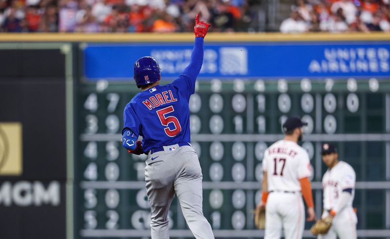 May 17, 2023; Houston, Texas, USA; Houston Astros second baseman David Hensley (17) and shortstop Jeremy Pena (3) look on as Chicago Cubs center fielder Christopher Morel (5) rounds the bases after hitting a home run during the fourth inning at Minute Maid Park. Mandatory Credit: Troy Taormina-USA TODAY Sports