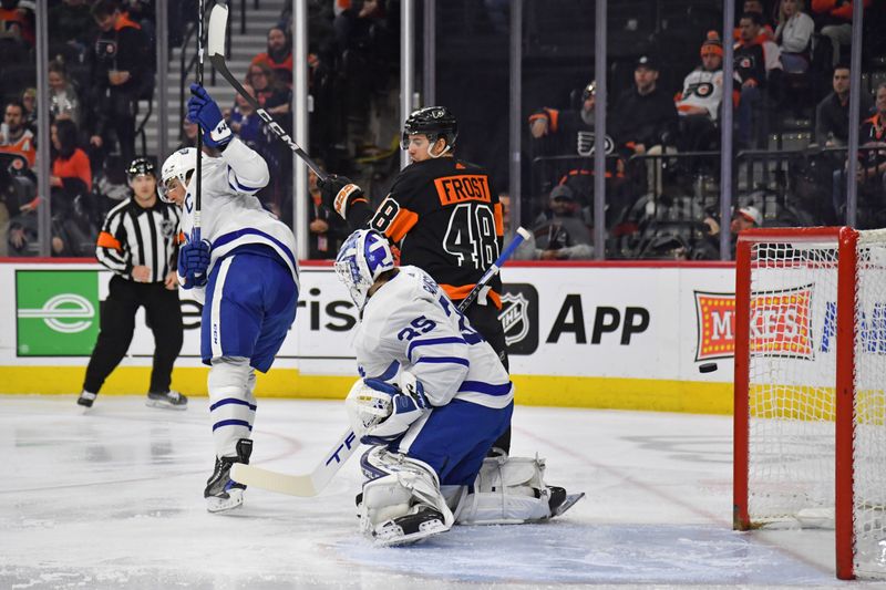 Mar 19, 2024; Philadelphia, Pennsylvania, USA; Toronto Maple Leafs goaltender Ilya Samsonov (35) allows goal as Philadelphia Flyers center Morgan Frost (48) and Toronto Maple Leafs center John Tavares (91) battle for position during the first period at Wells Fargo Center. Mandatory Credit: Eric Hartline-USA TODAY Sports