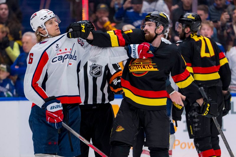 Jan 25, 2025; Vancouver, British Columbia, CAN; Washington Capitals defenseman Jakob Chychrun (6) fights Vancouver Canucks defenseman Filip Hronek (17) at the end of the game at Rogers Arena. Mandatory Credit: Bob Frid-Imagn Images