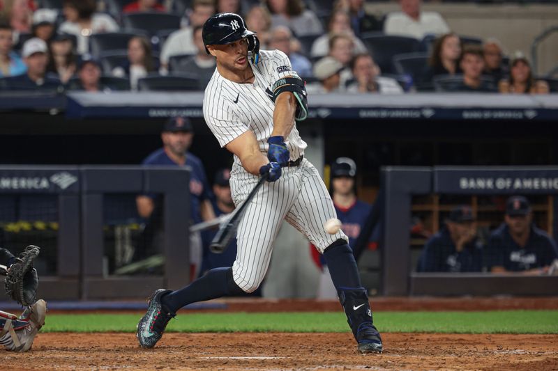 Sep 13, 2024; Bronx, New York, USA; New York Yankees designated hitter Giancarlo Stanton (27) singles during the sixth inning against the Boston Red Sox at Yankee Stadium. Mandatory Credit: Vincent Carchietta-Imagn Images