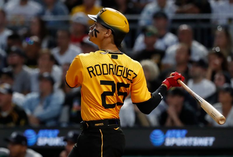 Sep 16, 2023; Pittsburgh, Pennsylvania, USA; Pittsburgh Pirates catcher Endy Rodriguez (25) drives in a run with a sacrifice fly against the New York Yankees during the third inning at PNC Park. Mandatory Credit: Charles LeClaire-USA TODAY Sports