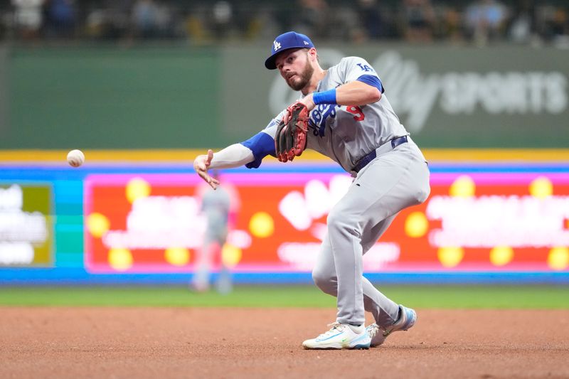 Aug 13, 2024; Milwaukee, Wisconsin, USA;  Los Angeles Dodgers second baseman Gavin Lux (9) throws to first base during the seventh inning against the Milwaukee Brewers at American Family Field. Mandatory Credit: Jeff Hanisch-USA TODAY Sports