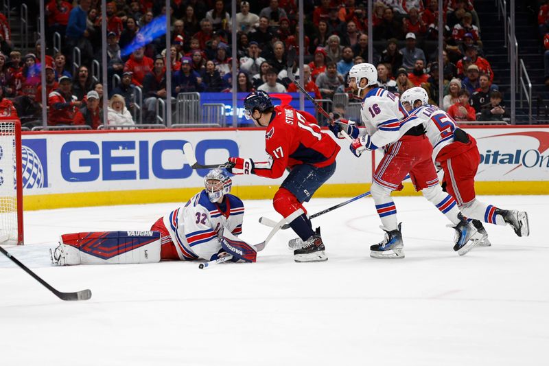 Jan 4, 2025; Washington, District of Columbia, USA; Washington Capitals center Dylan Strome (17) scores a goal on New York Rangers goaltender Jonathan Quick (32) in the first period at Capital One Arena. Mandatory Credit: Geoff Burke-Imagn Images