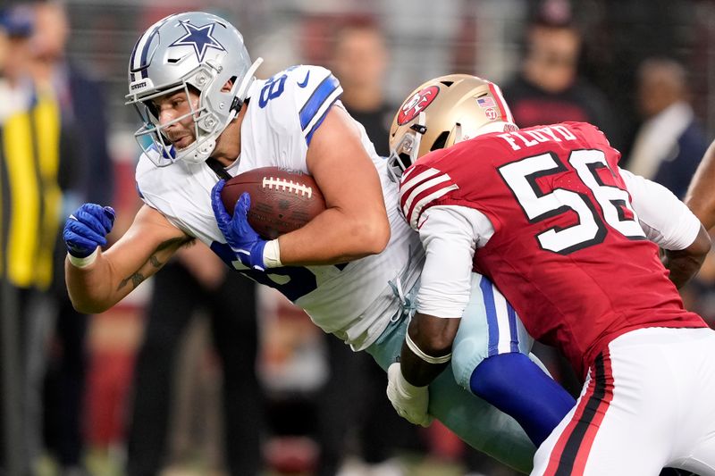 Dallas Cowboys tight end Jake Ferguson, left, runs against San Francisco 49ers defensive end Leonard Floyd (56) during the first half of an NFL football game in Santa Clara, Calif., Sunday, Oct. 27, 2024. (AP Photo/Tony Avelar)