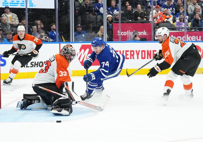 Feb 15, 2024; Toronto, Ontario, CAN; Toronto Maple Leafs center Bobby McMann (74) battles for the puck in front of Philadelphia Flyers goaltender Samuel Ersson (33) during the third period at Scotiabank Arena. Mandatory Credit: Nick Turchiaro-USA TODAY Sports