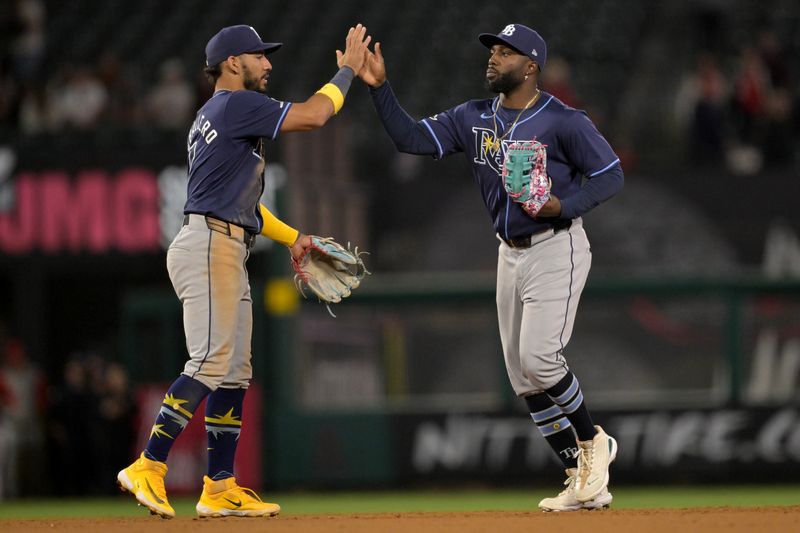 Apr 9, 2024; Anaheim, California, USA;  Tampa Bay Rays shortstop Jose Caballero (7) and outfielder Randy Arozarena (56) celebrate after the final out of the ninth inning to defeat the Los Angeles Angels at Angel Stadium. Mandatory Credit: Jayne Kamin-Oncea-USA TODAY Sports