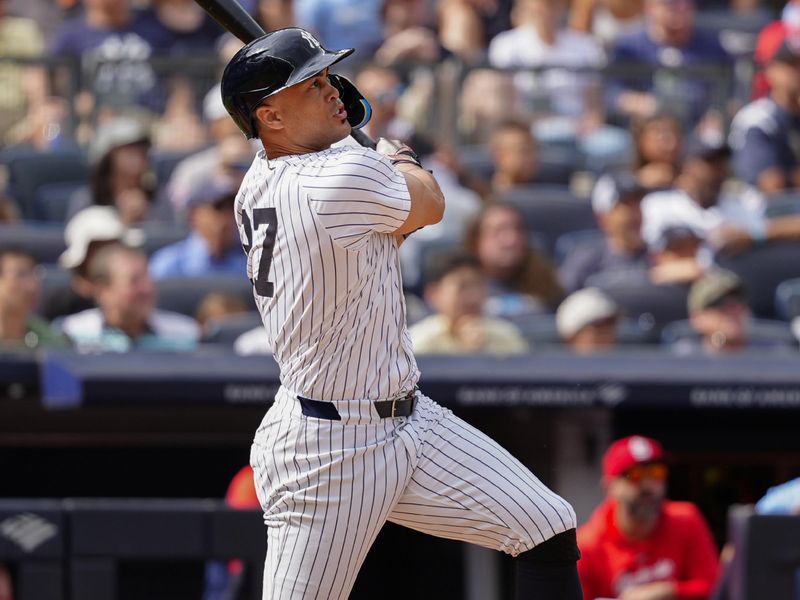 Aug 31, 2024; Bronx, New York, USA; New York Yankees designated hitter Giancarlo Stanton (27) hits an RBI double against the St. Louis Cardinals during the eighth inning at Yankee Stadium. Mandatory Credit: Gregory Fisher-USA TODAY Sports