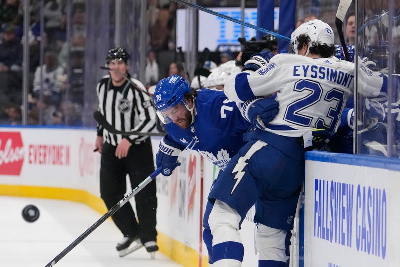 Apr 3, 2024; Toronto, Ontario, CAN; Toronto Maple Leafs defenseman TJ Brodie (78) knocks Tampa Bay Lightning forward Michael Eyssimont (23) off of the puck during the third period at Scotiabank Arena. Mandatory Credit: John E. Sokolowski-USA TODAY Sports