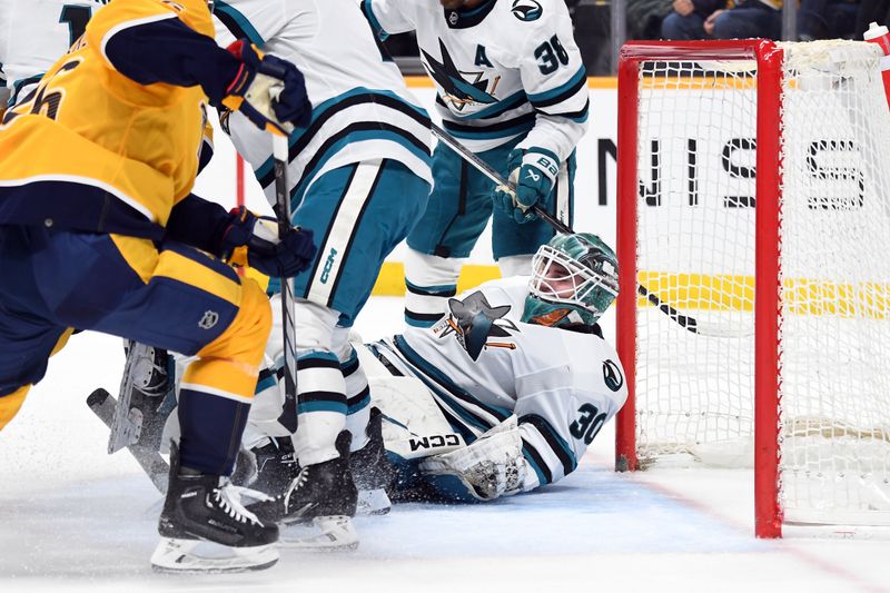 Mar 19, 2024; Nashville, Tennessee, USA; San Jose Sharks goaltender Magnus Chrona (30) covers the puck after a save during the first period against the Nashville Predators at Bridgestone Arena. Mandatory Credit: Christopher Hanewinckel-USA TODAY Sports