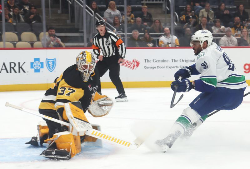 Oct 21, 2025; Pittsburgh, Pennsylvania, USA;  Pittsburgh Penguins goaltender Arturs Silovs (37) makes a save against Vancouver Canucks left wing Evander Kane (91) during the first period at PPG Paints Arena. Mandatory Credit: Charles LeClaire-Imagn Images