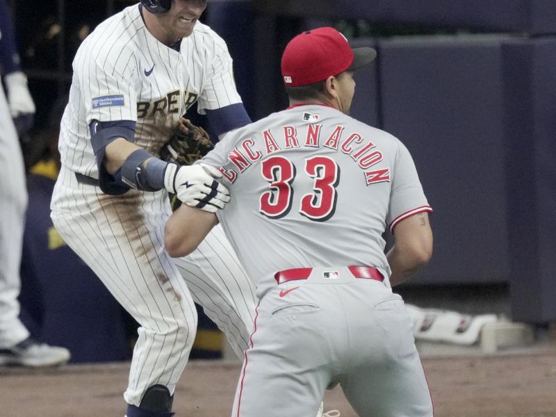 Apr 6, 2025; Milwaukee, Wisconsin, USA; Milwaukee Brewers' Oliver Dunn (15) is tagged out by Cincinnati Reds first base Christian Encarnacion-Strand (33) after hitting a sacrifice bunt during the fourth inning of their game at American Family Field. Mandatory Credit: Mark Hoffman-USA Today Network via Imagn Images 