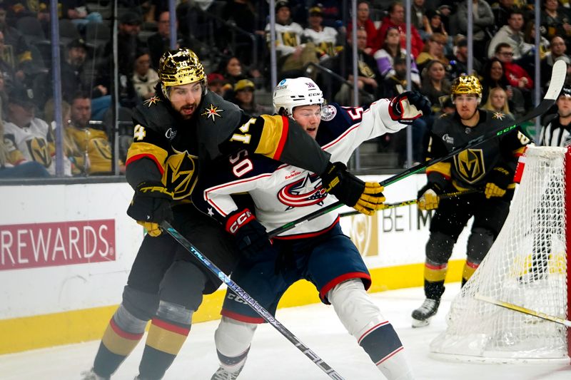 Mar 19, 2023; Las Vegas, Nevada, USA; Columbus Blue Jackets left wing Eric Robinson (50) skates against Vegas Golden Knights defenseman Nicolas Hague (14) during the first period at T-Mobile Arena. Mandatory Credit: Lucas Peltier-USA TODAY Sports