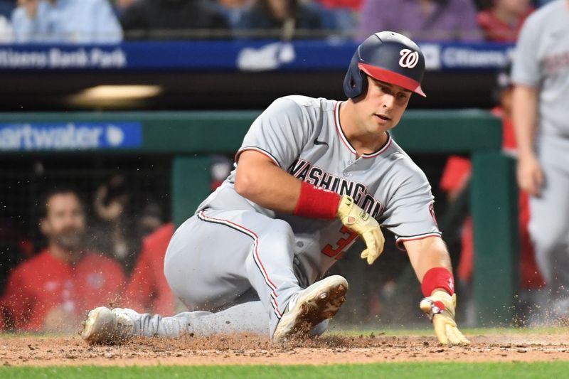 May 1, 2025; Philadelphia, Pennsylvania, USA;  Washington Nationals first base Nathaniel Lowe (33) slides safely into one during the sixth inning against the Philadelphia Phillies at Citizens Bank Park. Mandatory Credit: Eric Hartline-Imagn Images