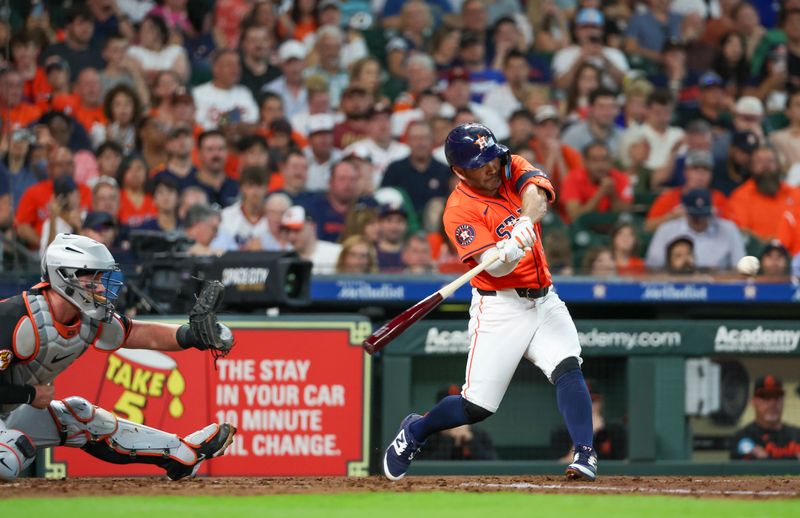 Jun 21, 2024; Houston, Texas, USA; Houston Astros second baseman Jose Altuve (27) hits a double against the Baltimore Orioles in the third inning at Minute Maid Park. Mandatory Credit: Thomas Shea-USA TODAY Sports