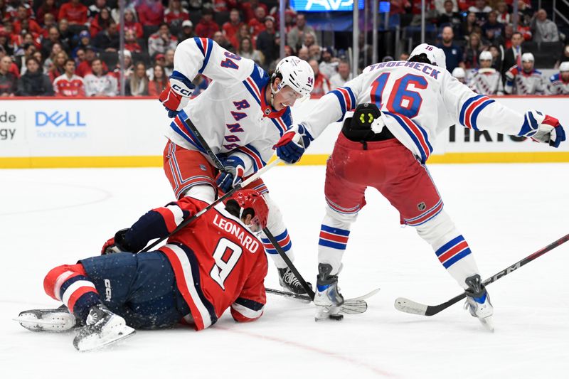 Dec 31, 2025; Washington, District of Columbia, USA; New York Rangers right wing Gabe Perreault (94) and center Vincent Trocheck (16) battle Washington Capitals right wing Ryan Leonard (9) for the puck during the first period at Capital One Arena. Mandatory Credit: Hannah Foslien-Imagn Images