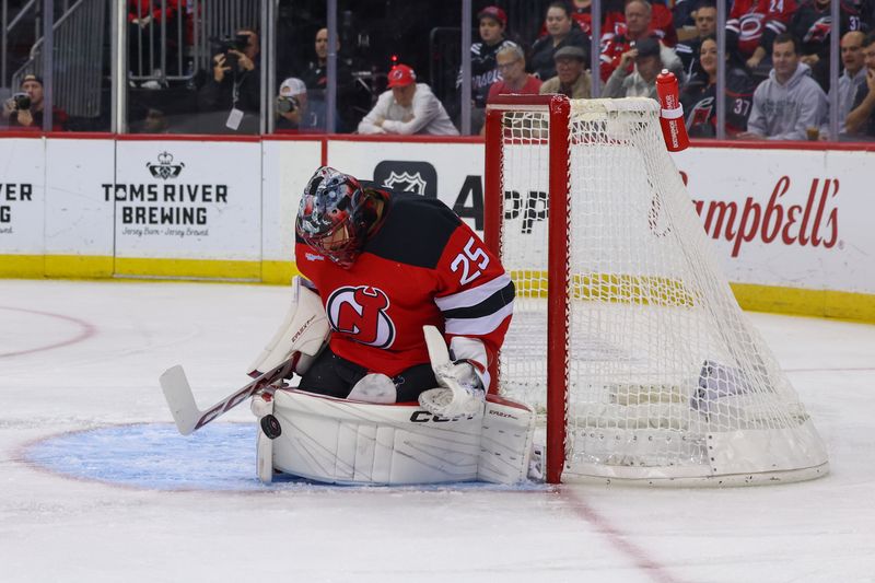 Nov 21, 2024; Newark, New Jersey, USA; New Jersey Devils goaltender Jacob Markstrom (25) makes a save against the Carolina Hurricanes during the first period at Prudential Center. Mandatory Credit: Ed Mulholland-Imagn Images