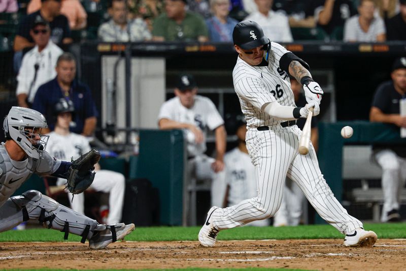 Aug 23, 2024; Chicago, Illinois, USA; Chicago White Sox catcher Korey Lee (26) hits an RBI-double against the Detroit Tigers during the fourth inning at Guaranteed Rate Field. Mandatory Credit: Kamil Krzaczynski-USA TODAY Sports