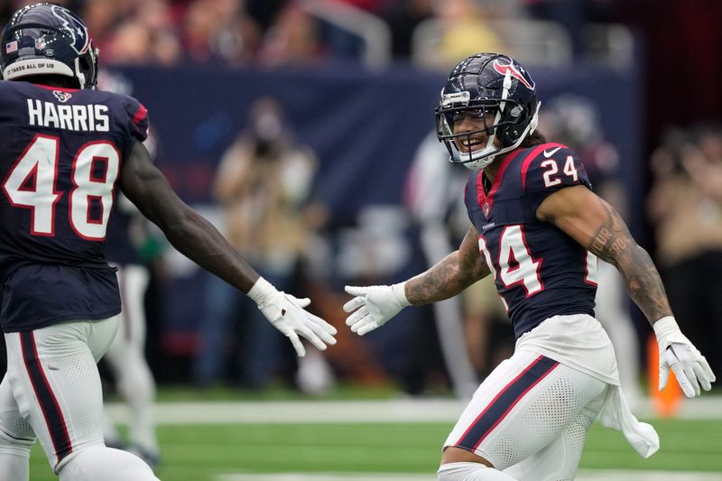 Houston Texans cornerback Derek Stingley Jr. (24) celebrates with linebacker Christian Harris (48) after defensive stop against the Tennessee Titans during the second half of an NFL football game Sunday, Dec. 31, 2023, in Houston. (AP Photo/David J. Phillip)