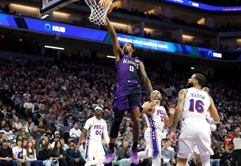 SACRAMENTO, CALIFORNIA - JANUARY 01: Malik Monk #0 of the Sacramento Kings drives to the basket for a layup against the Philadelphia 76ers during the first half of an NBA basketball game at Golden 1 Center on January 01, 2025 in Sacramento, California. NOTE TO USER: User expressly acknowledges and agrees that, by downloading and or using this photograph, User is consenting to the terms and conditions of the Getty Images License Agreement. (Photo by Thearon W. Henderson/Getty Images)