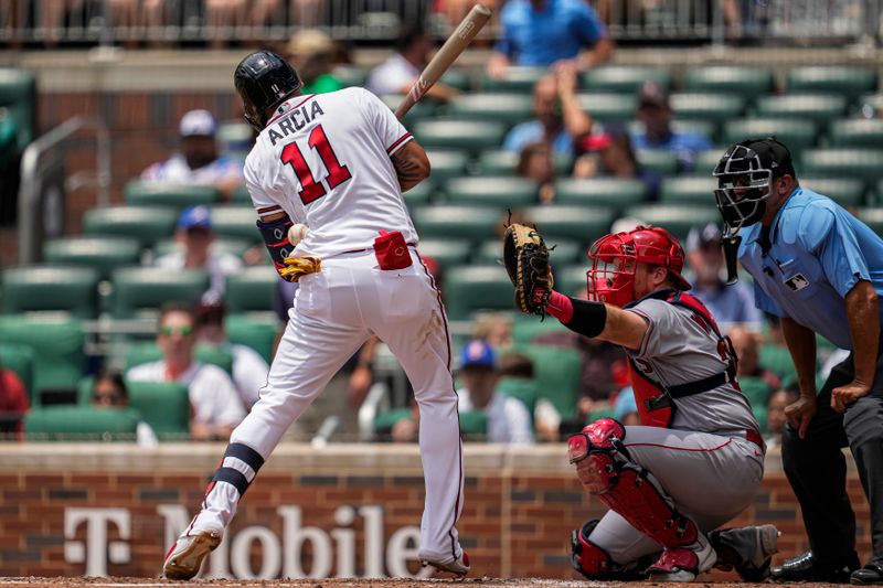 Aug 2, 2023; Cumberland, Georgia, USA; Atlanta Braves shortstop Orlando Arcia (11) is hit by a pitch against the Los Angeles Angels during the fourth inning at Truist Park. Mandatory Credit: Dale Zanine-USA TODAY Sports