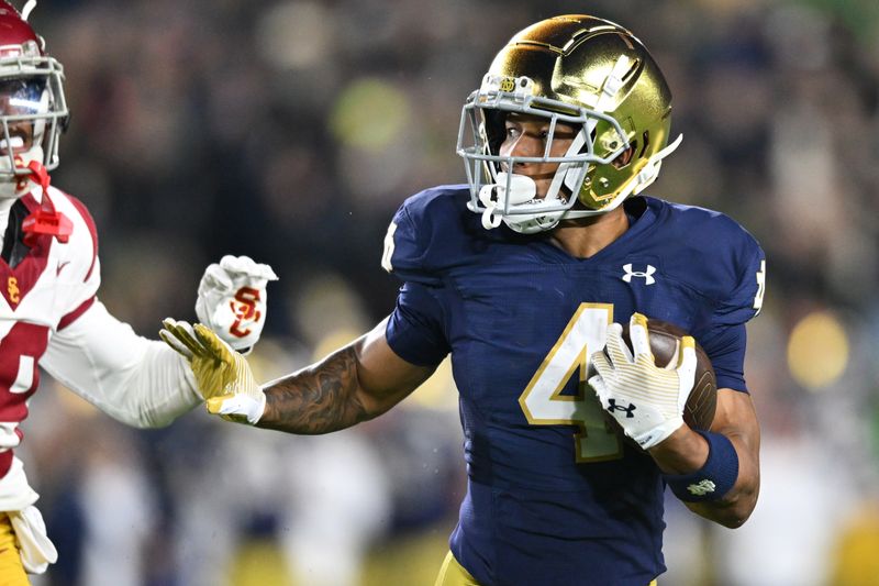 Oct 14, 2023; South Bend, Indiana, USA; Notre Dame Fighting Irish wide receiver Chris Tyree (4) catches a pass for a touchdown in the third quarter against the USC Trojans at Notre Dame Stadium. Mandatory Credit: Matt Cashore-USA TODAY Sports