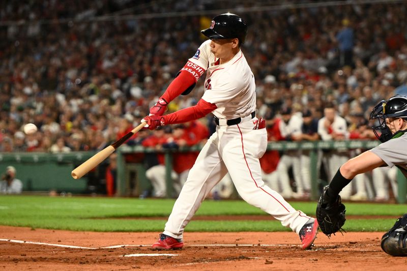 Sep 14, 2025; Boston, Massachusetts, USA;  Boston Red Sox left fielder Masataka Yoshida (7) hits a sacrifice fly for an RBI against the New York Yankees during the first inning at Fenway Park. Mandatory Credit: Brian Fluharty-Imagn Images