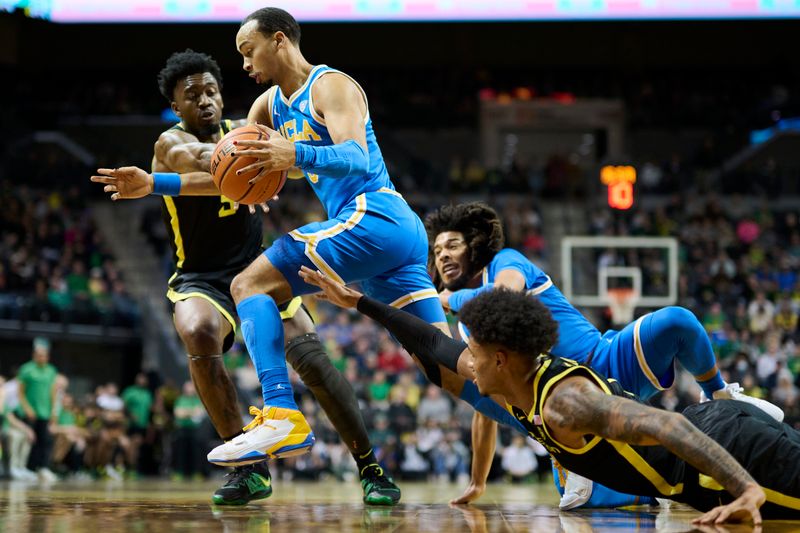 Feb 11, 2023; Eugene, Oregon, USA; UCLA Bruins guard Amari Bailey (5) dribbles the ball during the first half past Oregon Ducks guard Jermaine Couisnard (5) at Matthew Knight Arena. Mandatory Credit: Troy Wayrynen-USA TODAY Sports