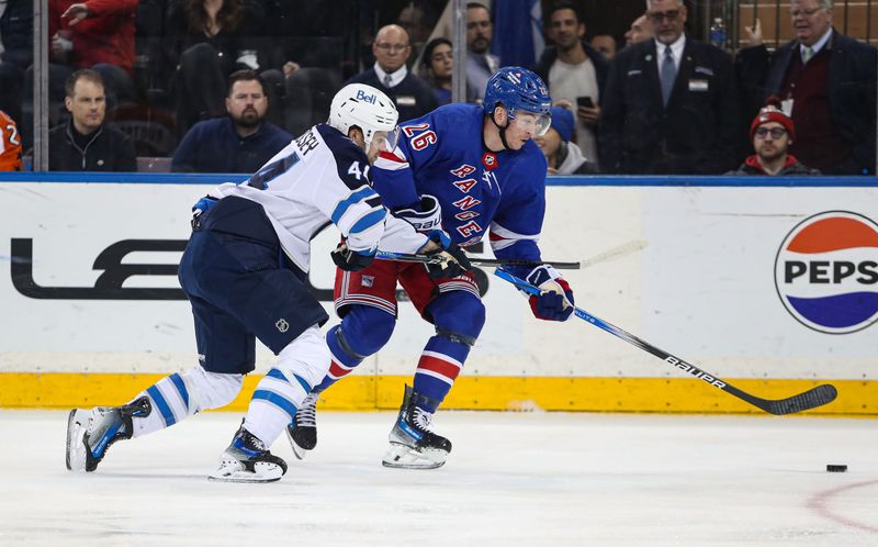 Mar 19, 2024; New York, New York, USA; New York Rangers left wing Jimmy Vesey (26) and Winnipeg Jets defenseman Josh Morrissey (44) battle for the puck during the second period at Madison Square Garden. Mandatory Credit: Danny Wild-USA TODAY Sports