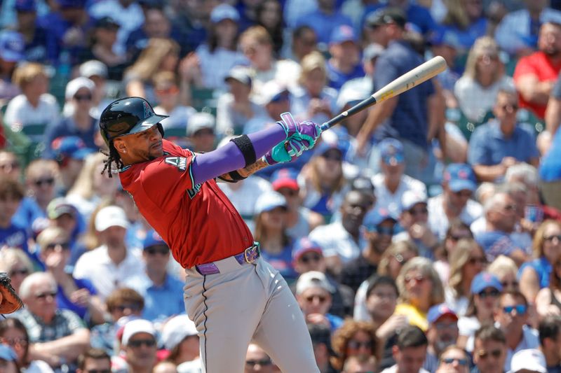 Jul 19, 2024; Chicago, Illinois, USA; Arizona Diamondbacks second baseman Ketel Marte (4) singles against the Chicago Cubs during the third inning at Wrigley Field. Mandatory Credit: Kamil Krzaczynski-USA TODAY Sports