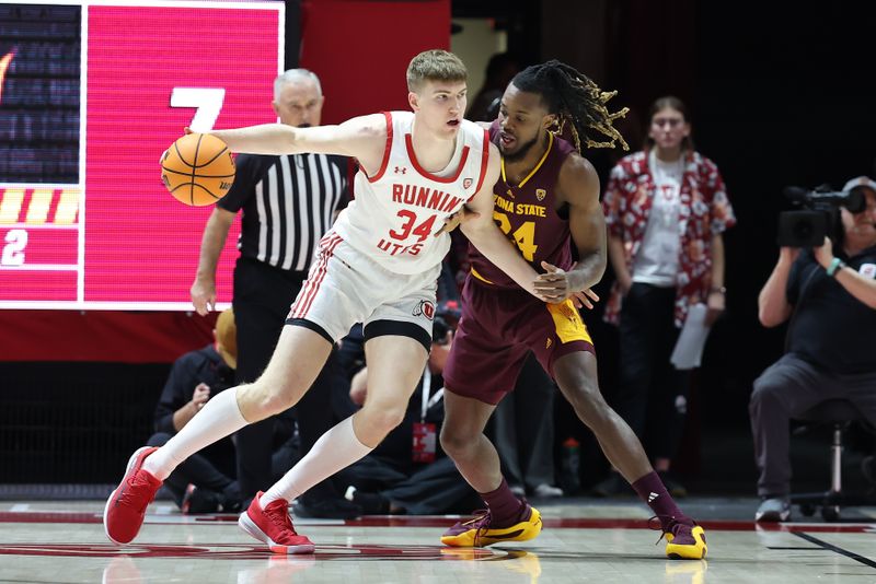 Feb 10, 2024; Salt Lake City, Utah, USA; Utah Utes center Lawson Lovering (34) dribbles to the basket against Arizona State Sun Devils forward Bryant Selebangue (24) during the first half at Jon M. Huntsman Center. Mandatory Credit: Rob Gray-USA TODAY Sports