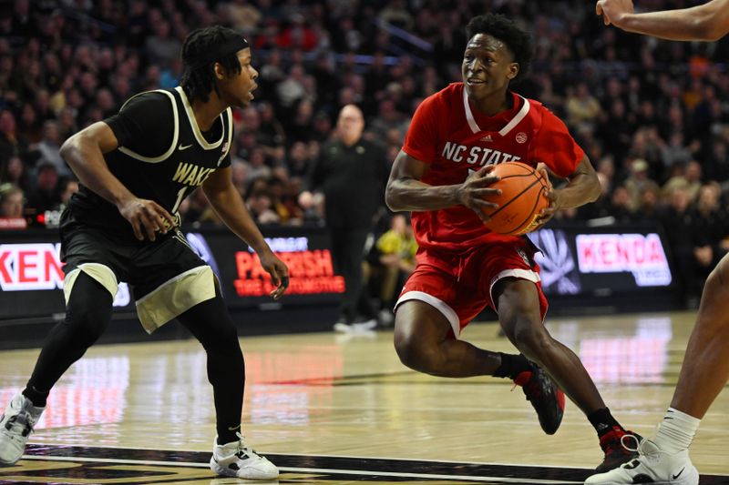 Jan 28, 2023; Winston-Salem, North Carolina, USA;  North Carolina State Wolfpack guard Jarkel Joiner (1) drives on Wake Forest Demon Deacons guard Tyree Appleby (1) during the second half at Lawrence Joel Veterans Memorial Coliseum. Mandatory Credit: William Howard-USA TODAY Sports