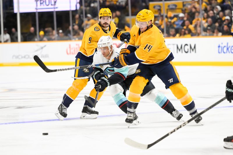 Oct 15, 2024; Nashville, Tennessee, USA; Nashville Predators center Gustav Nyquist (14) passes the puck against the Seattle Kraken  during the third period at Bridgestone Arena. Mandatory Credit: Steve Roberts-Imagn Images