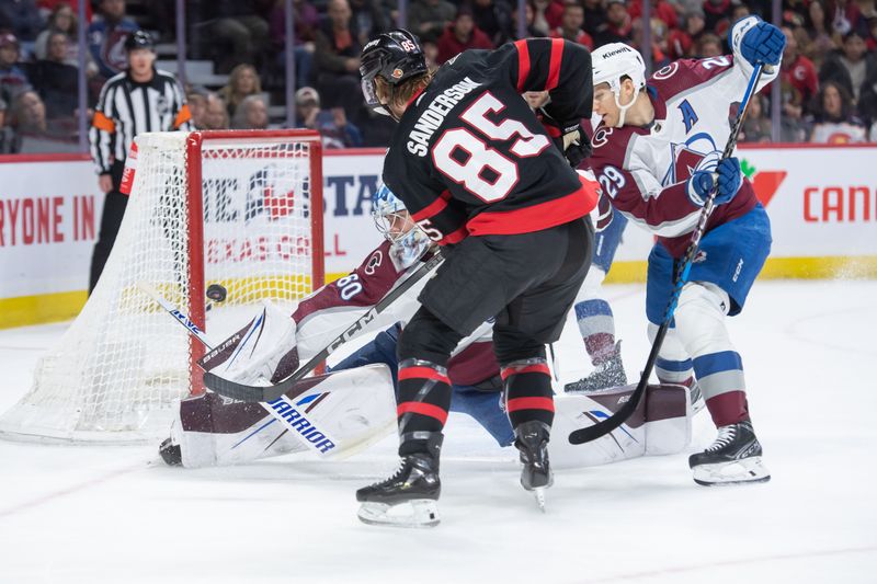 Jan 16, 2024; Ottawa, Ontario, CAN; Colorado Avalanche goalie Justus Annunen (60) makes a save on a shot from Ottawa Senators defenseman Jake Sanderson (85) in the first period at the Canadian Tire Centre. Mandatory Credit: Marc DesRosiers-USA TODAY Sports