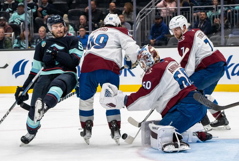 Oct 22, 2024; Seattle, Washington, USA;  Colorado Avalanche goalie Justus Annunen (60) knocks away a puck in a crowd including defenseman Samuel Girard (49), defenseman Devon Toews (7) and Seattle Kraken forward Shane Wright (51) during the second period at Climate Pledge Arena. Mandatory Credit: Stephen Brashear-Imagn Images