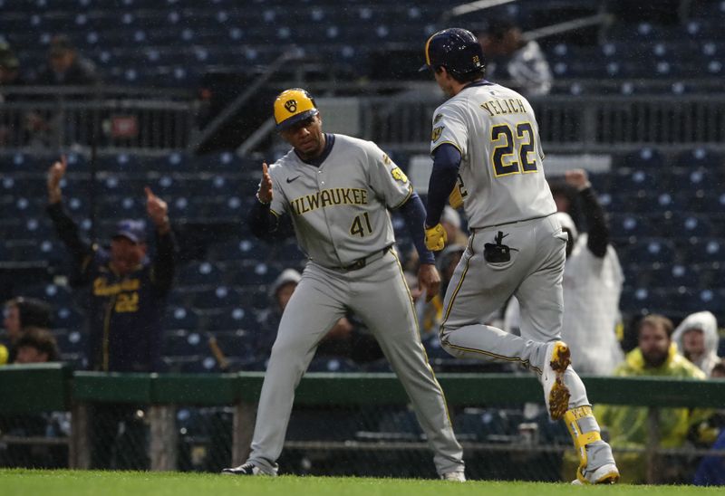 May 22, 2025; Pittsburgh, Pennsylvania, USA;  Milwaukee Brewers first base coach Julio Borbon (41) congratulates designated hitter Christian Yelich (22) circling the bases on a solo home run his second home run of the game against the Pittsburgh Pirates during the sixth inning at PNC Park. Mandatory Credit: Charles LeClaire-Imagn Images