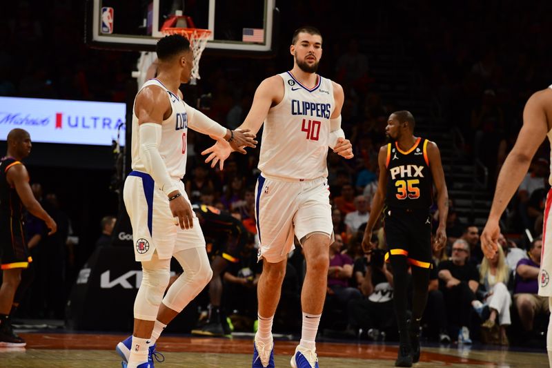 PHOENIX, AZ - APRIL  16: Russell Westbrook #0 of the LA Clippers high-fives teammate Ivica Zubac #40 during Round One Game One of the 2023 NBA Playoffs on April 16, 2023 at Footprint Center in Phoenix, Arizona. NOTE TO USER: User expressly acknowledges and agrees that, by downloading and or using this photograph, user is consenting to the terms and conditions of the Getty Images License Agreement. Mandatory Copyright Notice: Copyright 2023 NBAE (Photo by Kate Frese/NBAE via Getty Images)