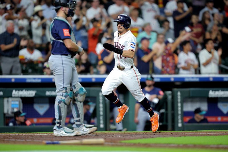 May 22, 2025; Houston, Texas, USA; Houston Astros second baseman Mauricio Dubon (14) crosses home plate to score a run against the Seattle Mariners during the fourth inning at Daikin Park. Mandatory Credit: Erik Williams-Imagn Images