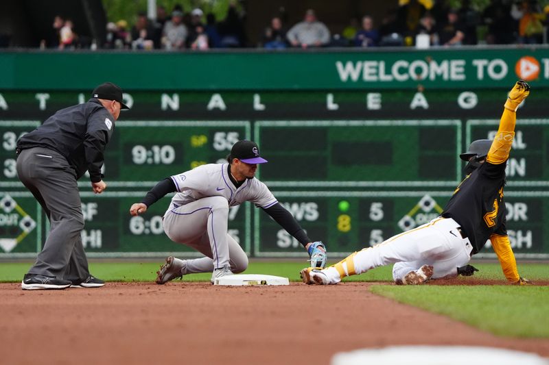 May 4, 2024; Pittsburgh, Pennsylvania, USA; Colorado Rockies shortstop Ezequiel Tovar (14) tags out Pittsburgh Pirates first baseman Connor Joe (2) attempting to stretch a single into a double during the second inning at PNC Park. Mandatory Credit: Gregory Fisher-USA TODAY Sports