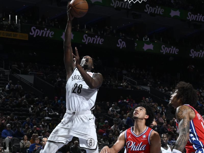 PHILADELPHIA, PA - NOVEMBER 22: Dorian Finney-Smith #28 of the Brooklyn Nets drives to the basket during the game against the Philadelphia 76ers during the Emirates NBA Cup game on November 22, 2024 at the Wells Fargo Center in Philadelphia, Pennsylvania NOTE TO USER: User expressly acknowledges and agrees that, by downloading and/or using this Photograph, user is consenting to the terms and conditions of the Getty Images License Agreement. Mandatory Copyright Notice: Copyright 2024 NBAE (Photo by David Dow/NBAE via Getty Images)