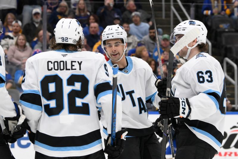 Nov 7, 2024; St. Louis, Missouri, USA; Utah Hockey Club right wing Dylan Guenther (11) is congratulated by teammates after scoring a goal against the St. Louis Blues during the third period at Enterprise Center. Mandatory Credit: Jeff Le-Imagn Images