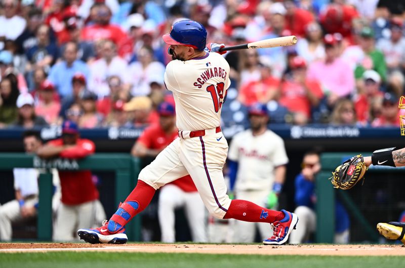 Jun 5, 2024; Philadelphia, Pennsylvania, USA; Philadelphia Phillies designated hitter Kyle Schwarber (12) hits a single against the Milwaukee Brewers in the first inning at Citizens Bank Park. Mandatory Credit: Kyle Ross-USA TODAY Sports