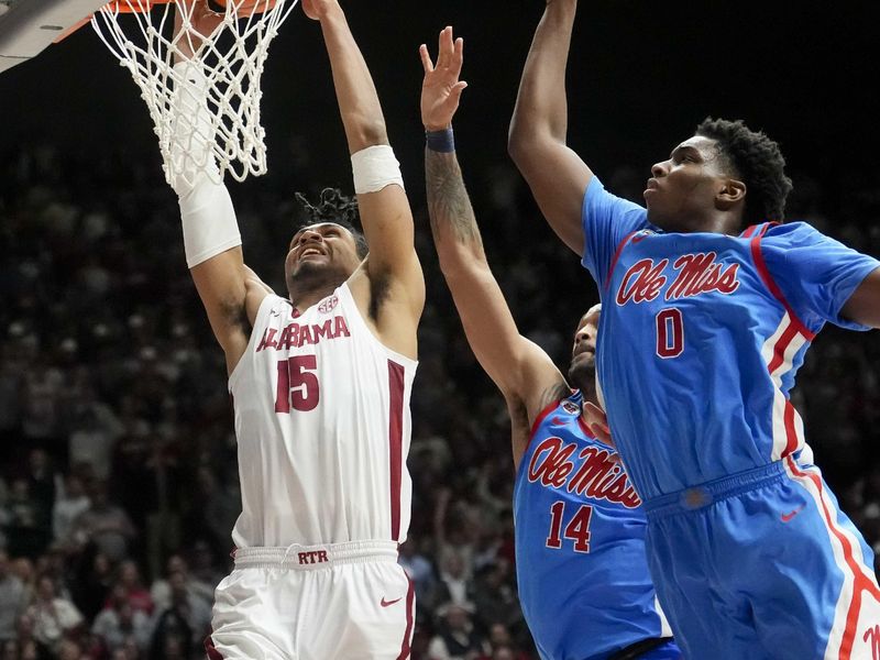 Jan 14, 2025; Tuscaloosa, AL, USA; Alabama forward Jarin Stevenson (15) dunks against Ole Miss guard Dre Davis (14) and Ole Miss forward Malik Dia (0) at Coleman Coliseum. Ole Miss defeated Alabama 74-64. Mandatory Credit: Gary Cosby Jr./USA TODAY Network via Imagn Images