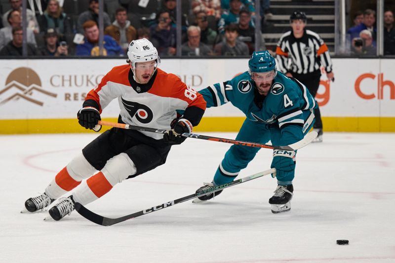 Nov 7, 2023; San Jose, California, USA; Philadelphia Flyers left wing Joel Farabee (86) battles for control of a loose puck with San Jose Sharks defenseman Kyle Burroughs (4) during the first period at SAP Center at San Jose. Mandatory Credit: Robert Edwards-USA TODAY Sports