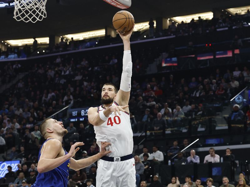 INGLEWOOD, CALIFORNIA - DECEMBER 01:  Ivica Zubac #40 of the LA Clippers takes a shot against Nikola Jokic #15 of the Denver Nuggets in the first half at Intuit Dome on December 01, 2024 in Inglewood, California.  NOTE TO USER: User expressly acknowledges and agrees that, by downloading and or using this photograph, User is consenting to the terms and conditions of the Getty Images License Agreement. (Photo by Ronald Martinez/Getty Images)